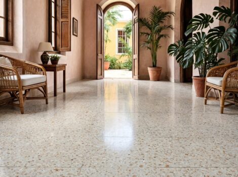 Polished beige terrazzo floor tiles in a tropical Puerto Rico entryway with arched doorways and wicker furniture.