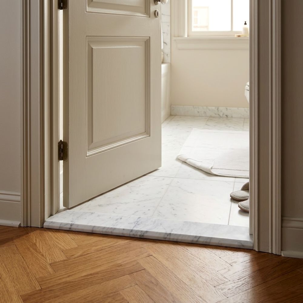 White Carrara honed marble threshold at a bathroom door in San Juan, Puerto Rico